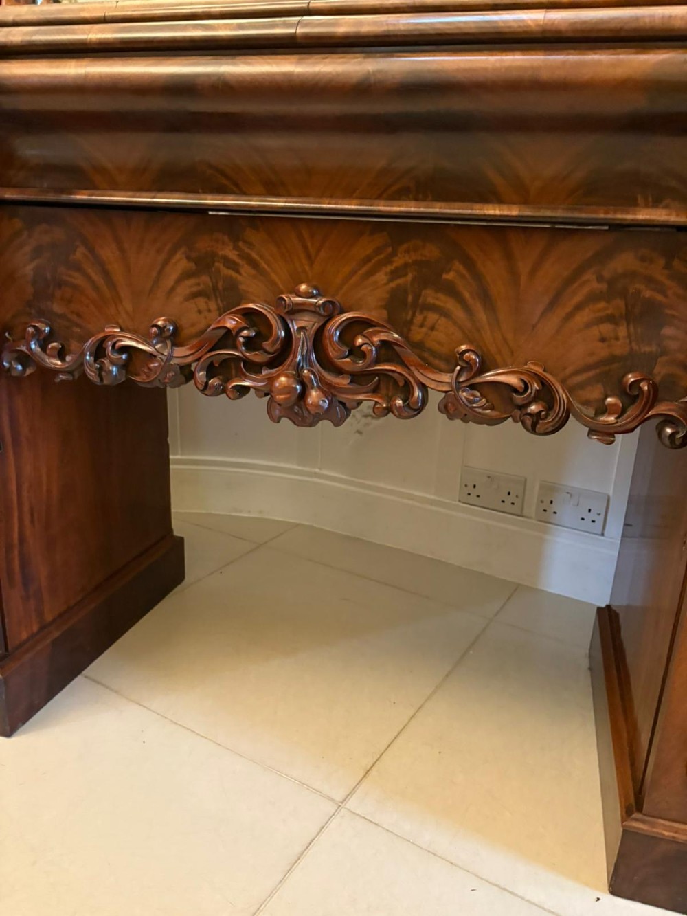 An antique Victorian carved mahogany sideboard featuring twin pedestal bases with carved scroll mouldings and a large arched mirror-backed top frame. View VII