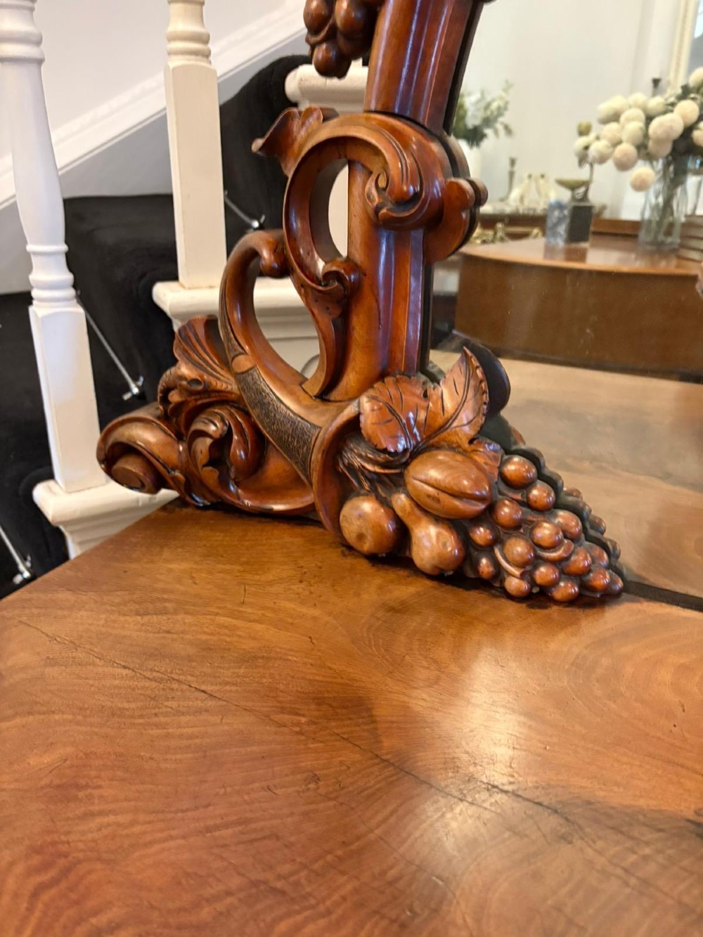An antique Victorian carved mahogany sideboard featuring twin pedestal bases with carved scroll mouldings and a large arched mirror-backed top frame. View X