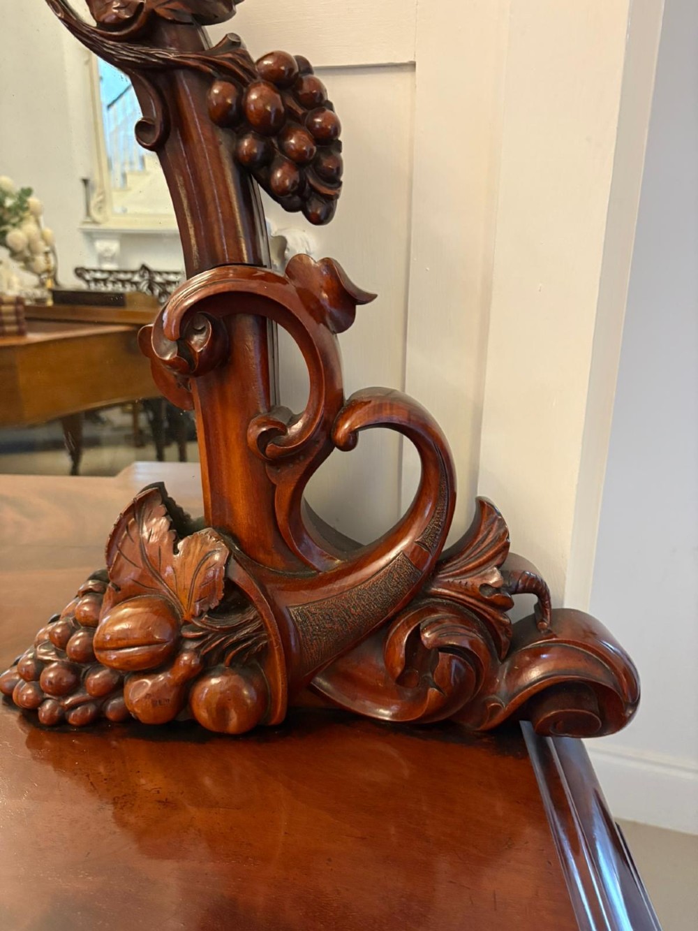 An antique Victorian carved mahogany sideboard featuring twin pedestal bases with carved scroll mouldings and a large arched mirror-backed top frame. View XII