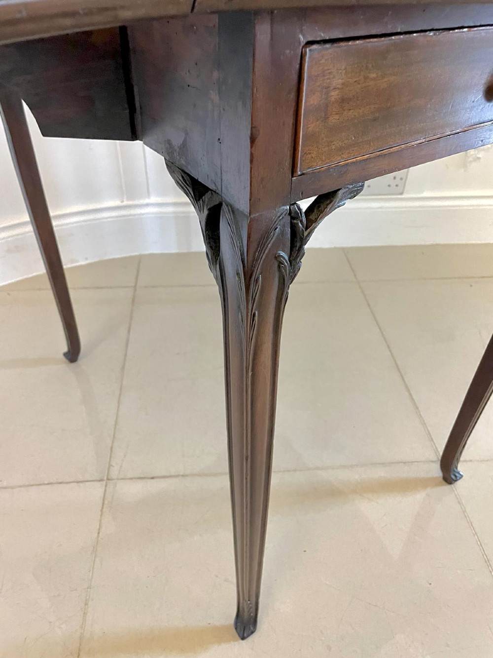 An eighteenth-century George III mahogany Pembroke table with butterfly drop leaves, central fan inlay, and slender legs. View III