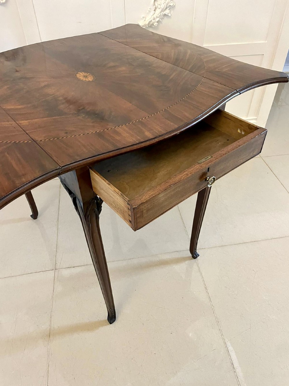 An eighteenth-century George III mahogany Pembroke table with butterfly drop leaves, central fan inlay, and slender legs. View IV