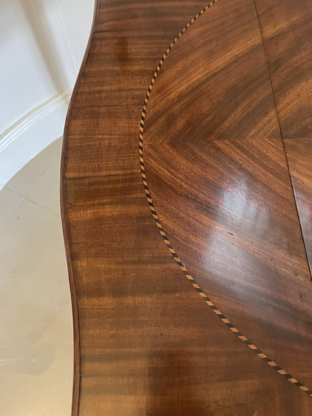 An eighteenth-century George III mahogany Pembroke table with butterfly drop leaves, central fan inlay, and slender legs. View V