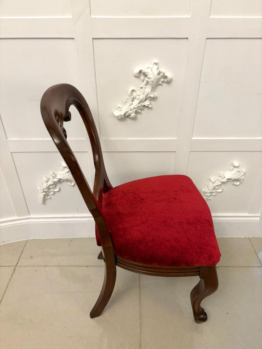 A set of six Victorian mahogany balloon back dining chairs with cabriole legs and crimson red velvet upholstered seats. View II