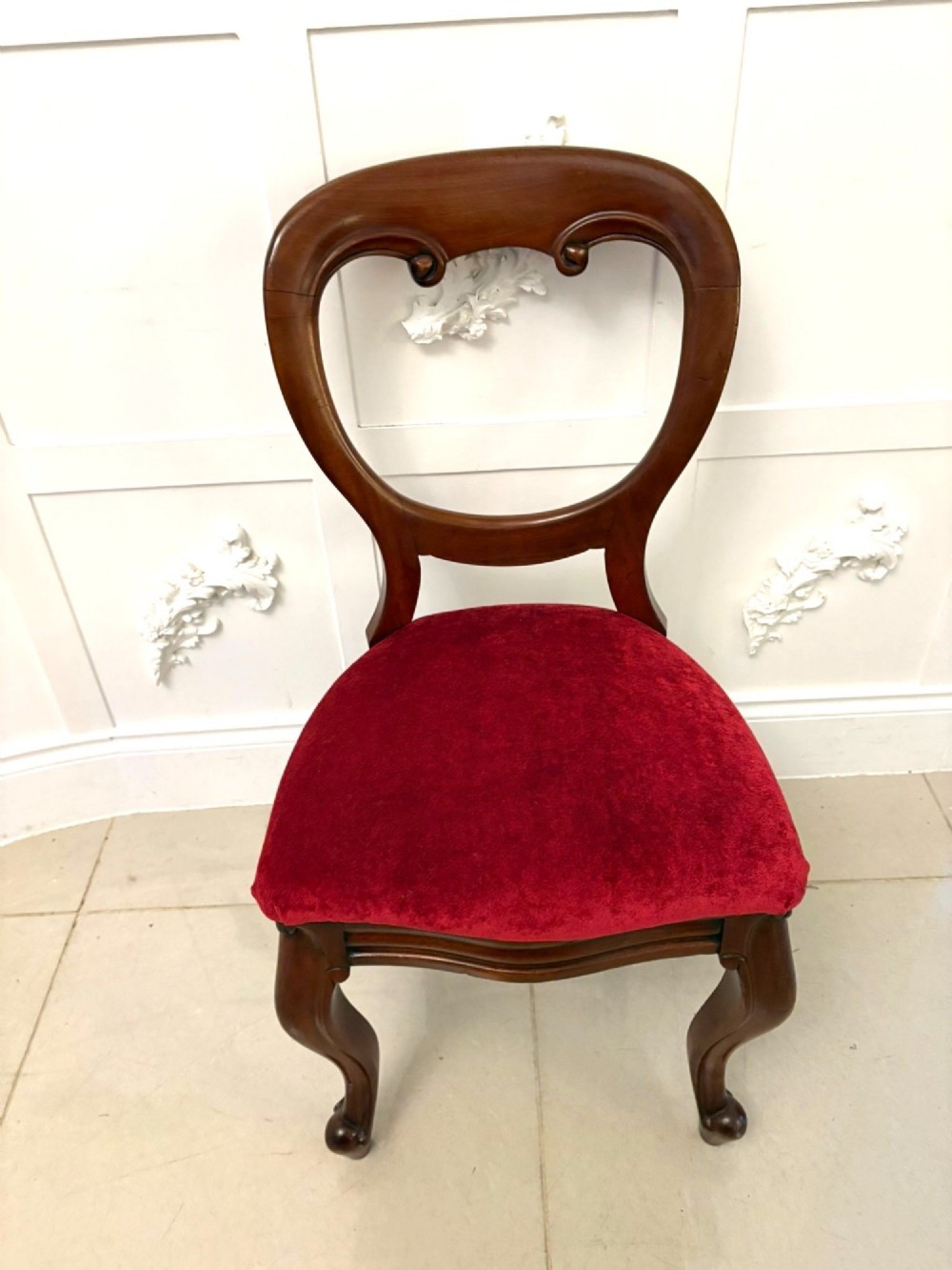 A set of six Victorian mahogany balloon back dining chairs with cabriole legs and crimson red velvet upholstered seats. View III