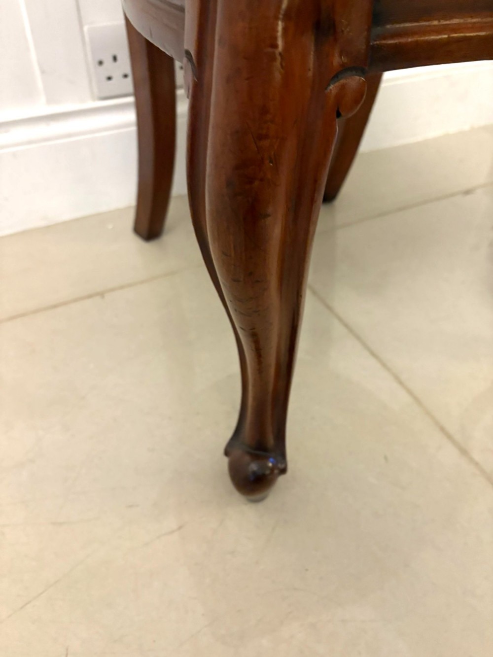 A set of six Victorian mahogany balloon back dining chairs with cabriole legs and crimson red velvet upholstered seats. View VI