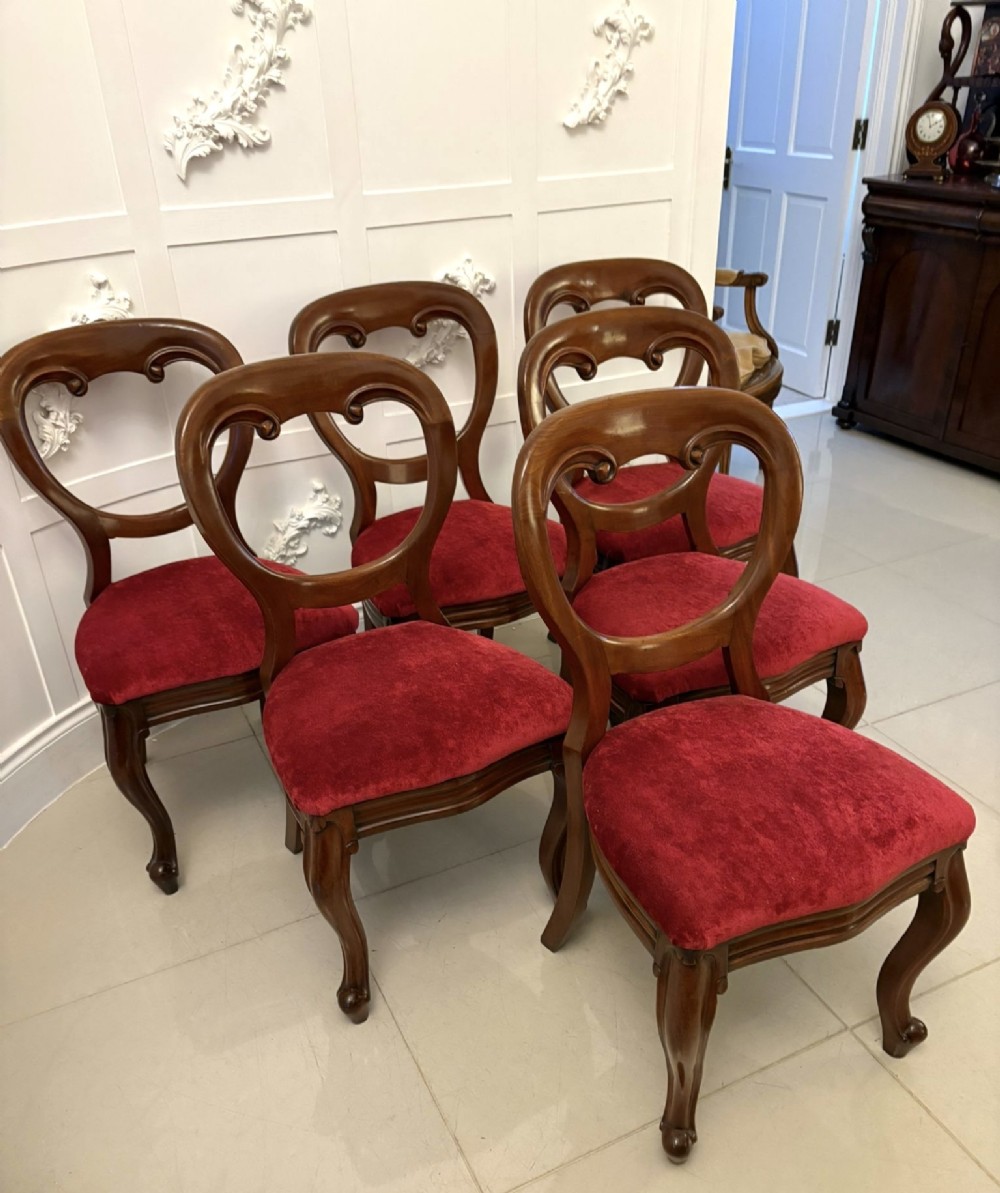 A set of six Victorian mahogany balloon back dining chairs with cabriole legs and crimson red velvet upholstered seats. View XI