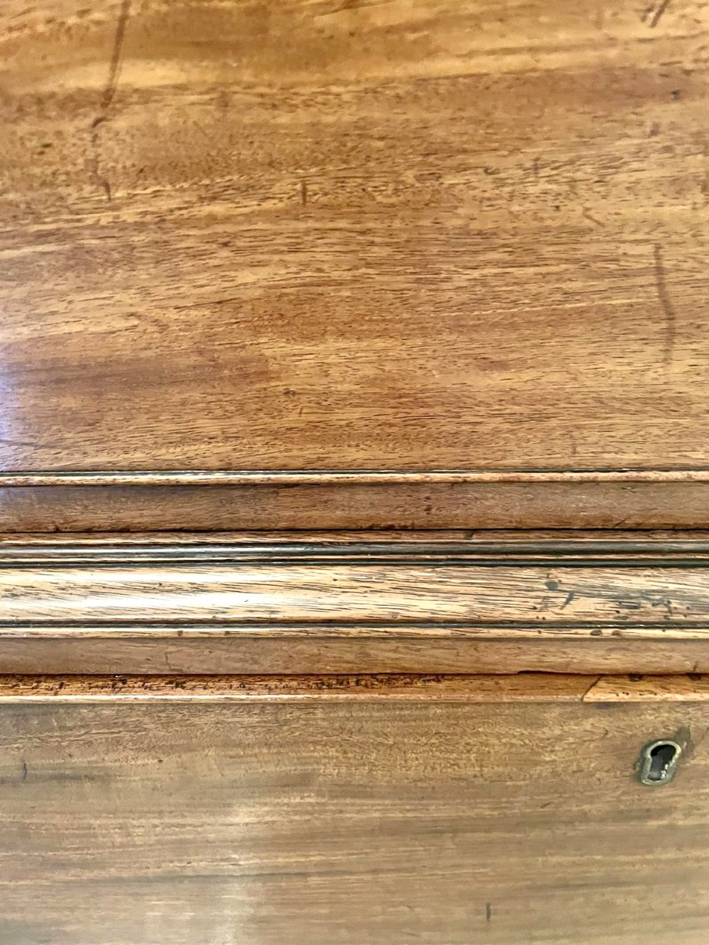 A tall George III figured mahogany chest on chest featuring two short drawers above five long drawers, fitted with oval brass drop handles and supported on bracket feet. View II