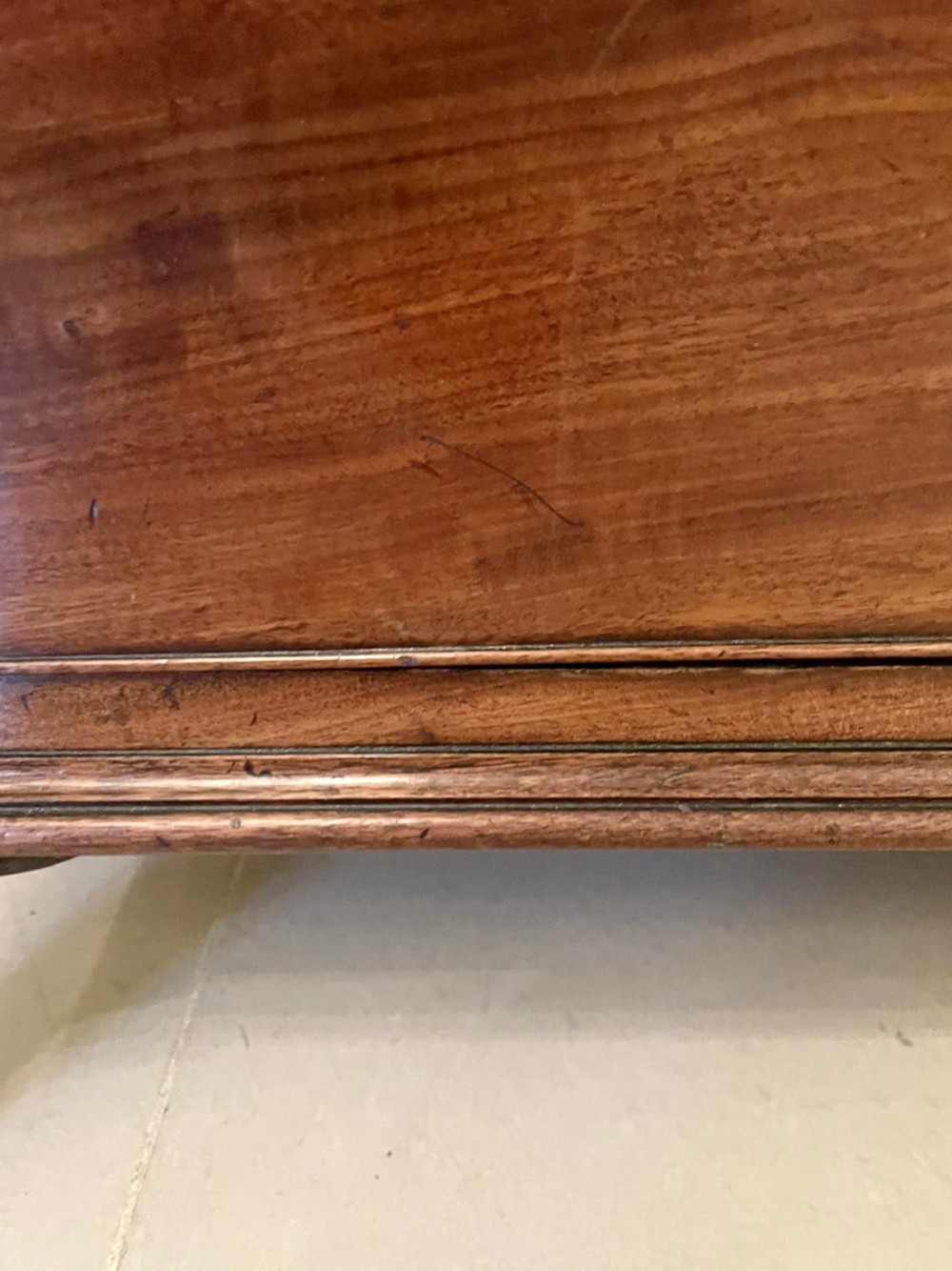 A tall George III figured mahogany chest on chest featuring two short drawers above five long drawers, fitted with oval brass drop handles and supported on bracket feet. View VI
