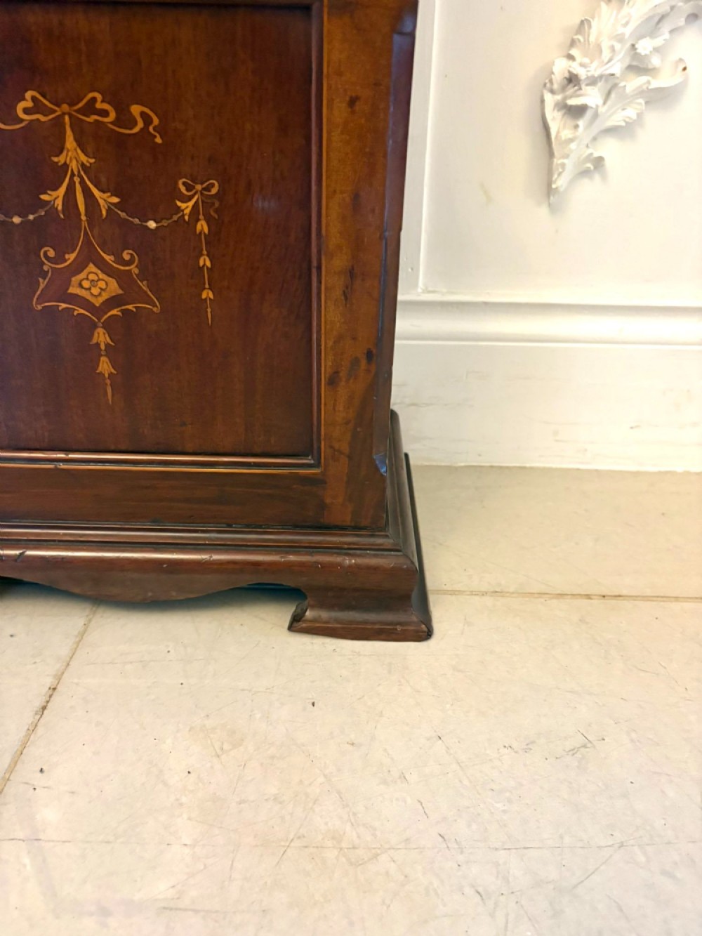 An Edwardian mahogany longcase clock with satinwood urn inlay on the door and a brass dial with Tempus Fugit inscription. View VI