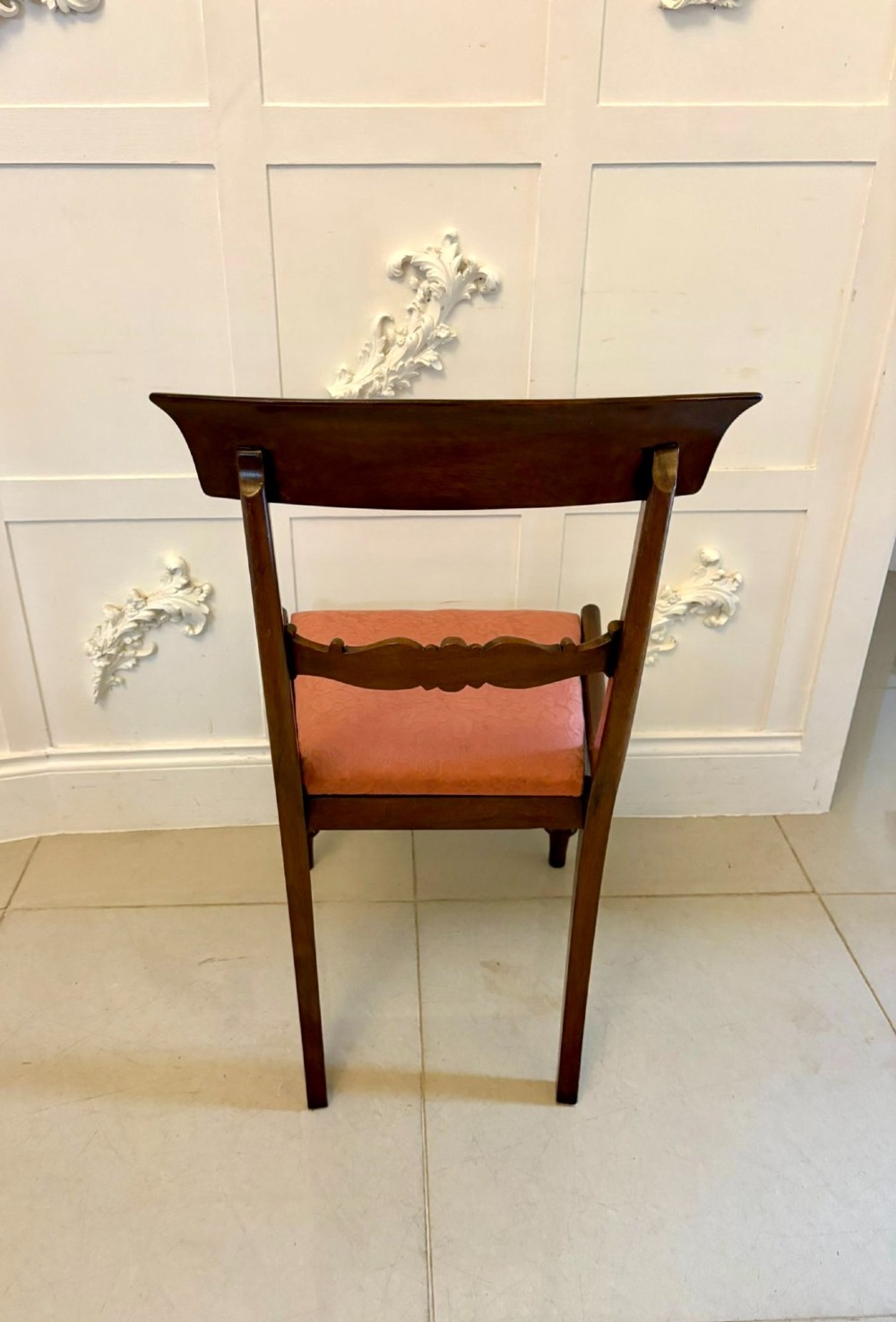 Set of six antique William IV mahogany dining chairs with curved crest rails, scroll carved crossbars, turned front legs, and pink damask upholstered drop-in seats. View II