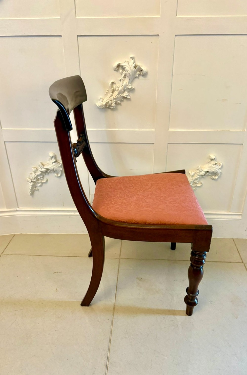 Set of six antique William IV mahogany dining chairs with curved crest rails, scroll carved crossbars, turned front legs, and pink damask upholstered drop-in seats. View VI