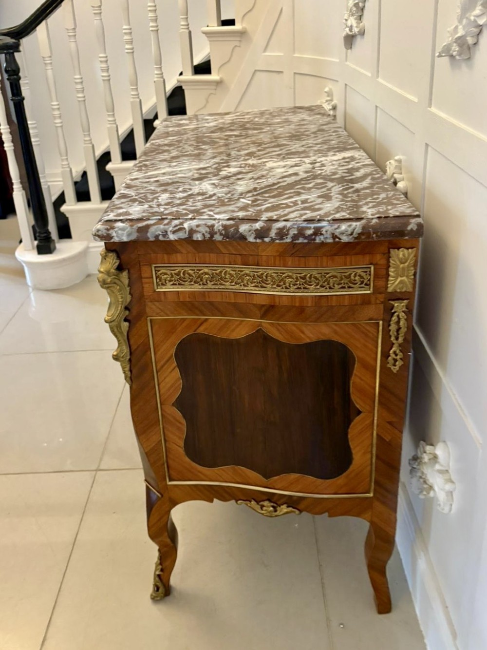 An antique French style commode chest featuring a dark grey veined marble top, decorative walnut veneers, cast brass mounts, and cabriole legs. View XI