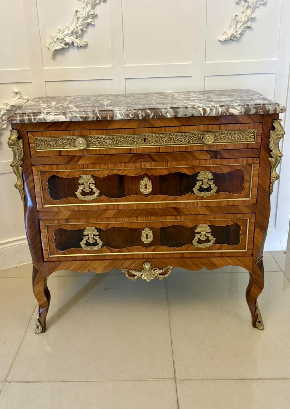 An antique French style commode chest featuring a dark grey veined marble top, decorative walnut veneers, cast brass mounts, and cabriole legs. View XIII