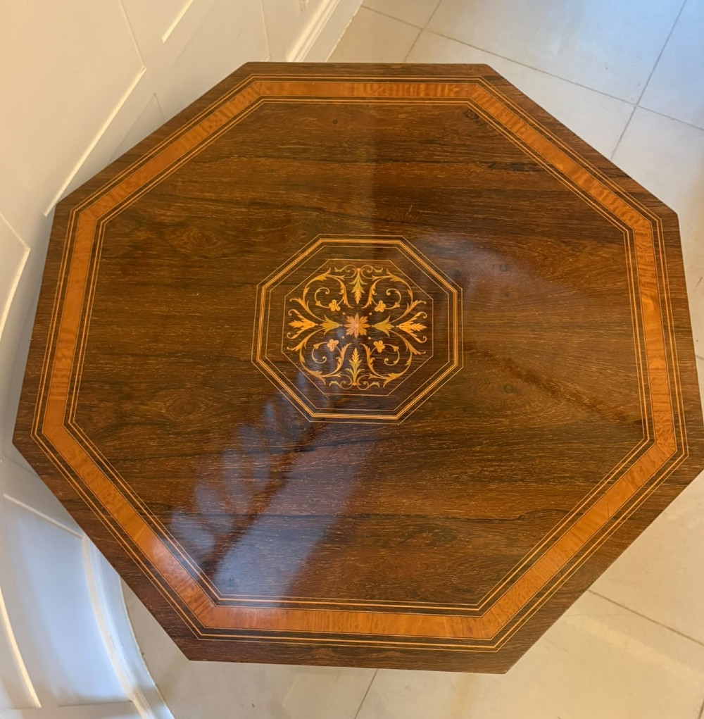 An octagonal Victorian rosewood centre table with intricate central marquetry inlay, crossbanded borders, and spiral turned legs joined by a lower stretcher. View II