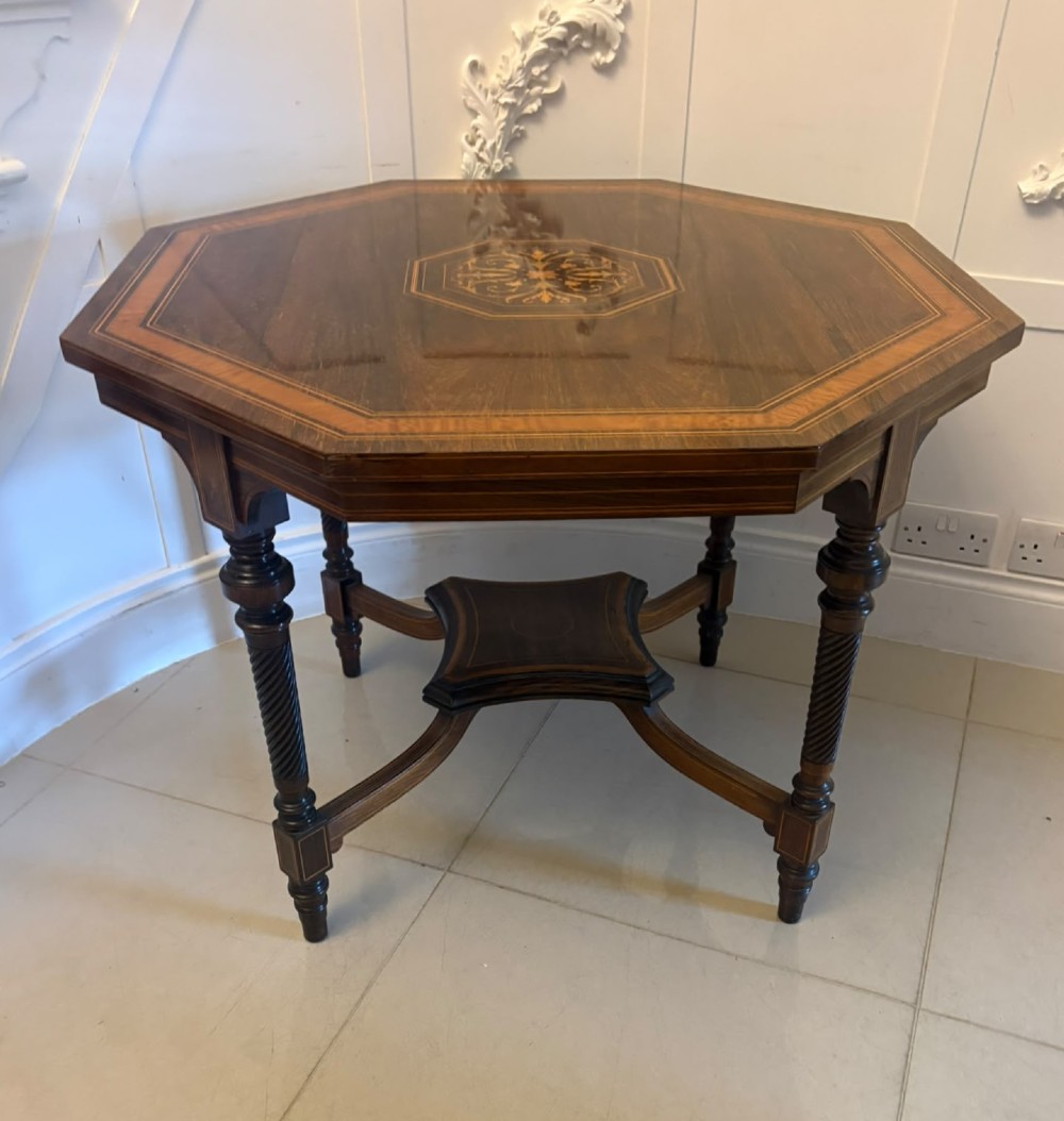 An octagonal Victorian rosewood centre table with intricate central marquetry inlay, crossbanded borders, and spiral turned legs joined by a lower stretcher. View VI