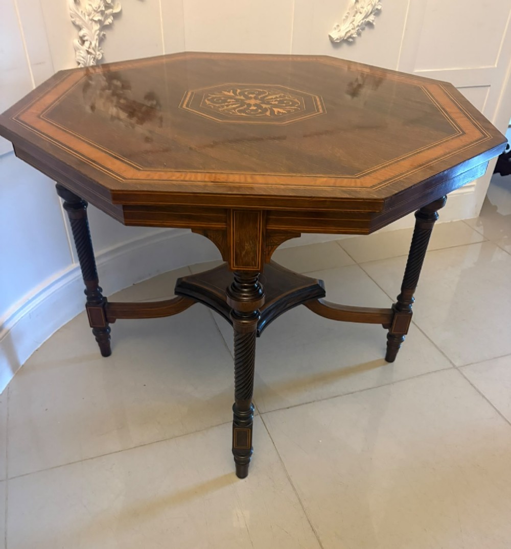 An octagonal Victorian rosewood centre table with intricate central marquetry inlay, crossbanded borders, and spiral turned legs joined by a lower stretcher. View X