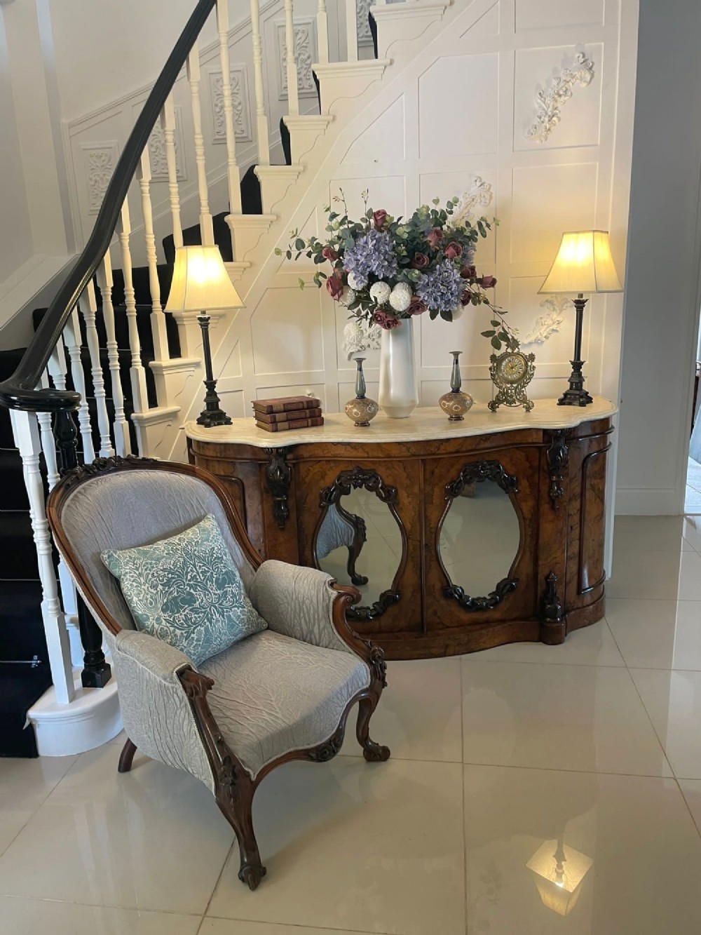 A Victorian burr walnut credenza featuring a serpentine white marble top above two central oval mirrored doors and carved scroll accents. View X