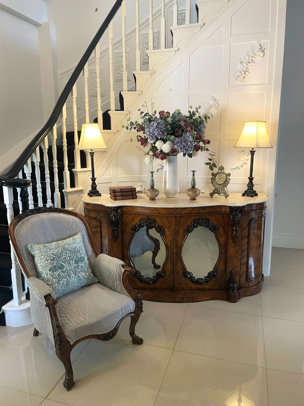 A Victorian burr walnut credenza featuring a serpentine white marble top above two central oval mirrored doors and carved scroll accents. View XII