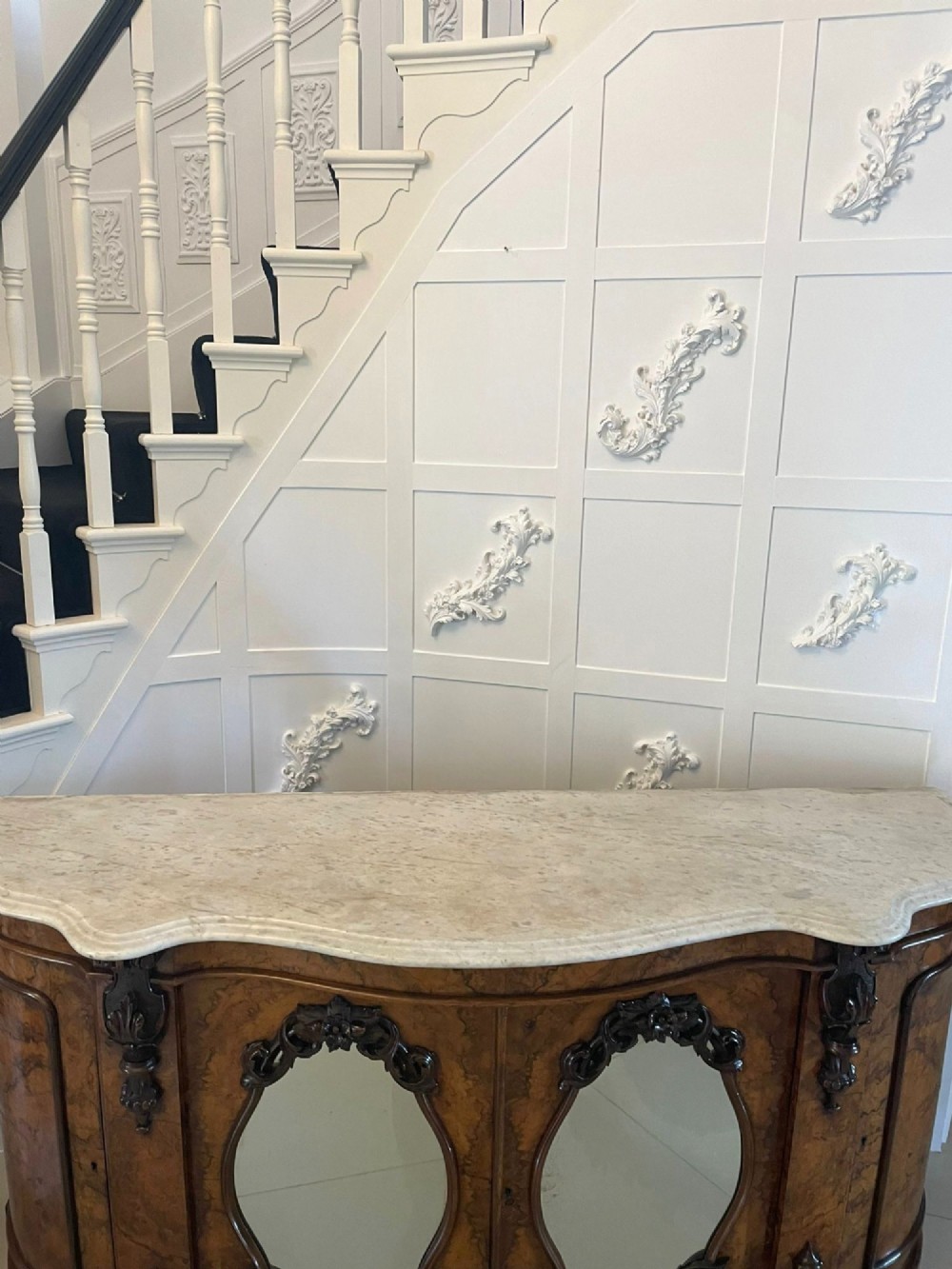 A Victorian burr walnut credenza featuring a serpentine white marble top above two central oval mirrored doors and carved scroll accents. View XIV