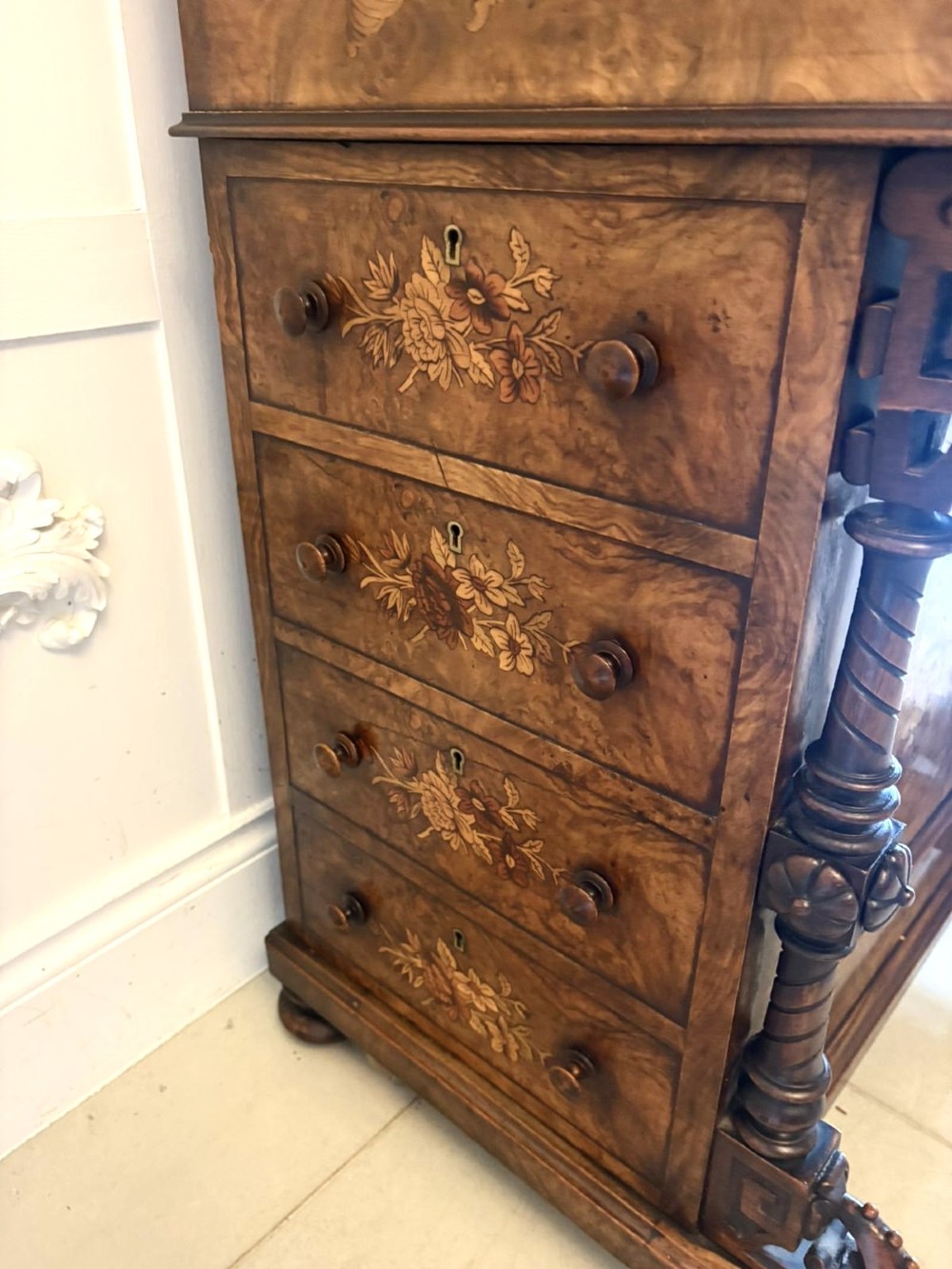 A Victorian burr walnut piano top davenport desk featuring floral marquetry, side drawers with turned wooden knobs, and carved supports. View XI