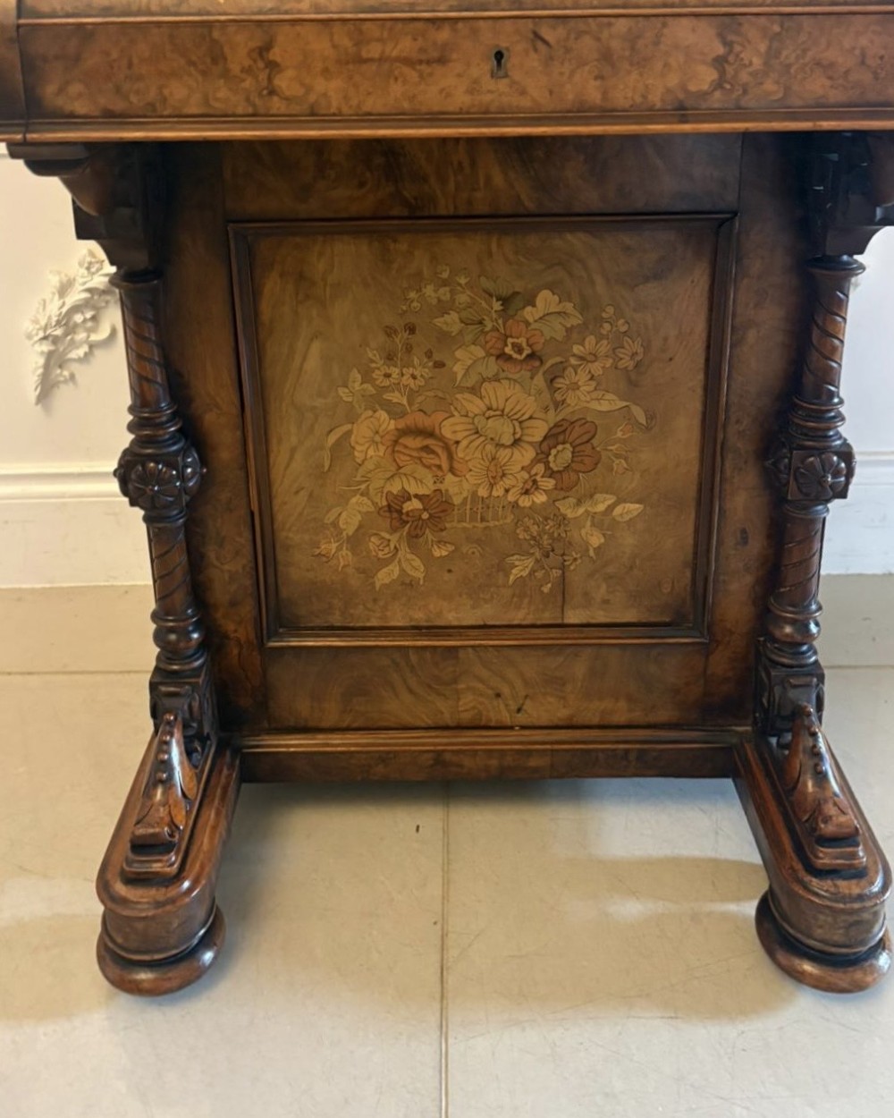 A Victorian burr walnut piano top davenport desk featuring floral marquetry, side drawers with turned wooden knobs, and carved supports. View XII