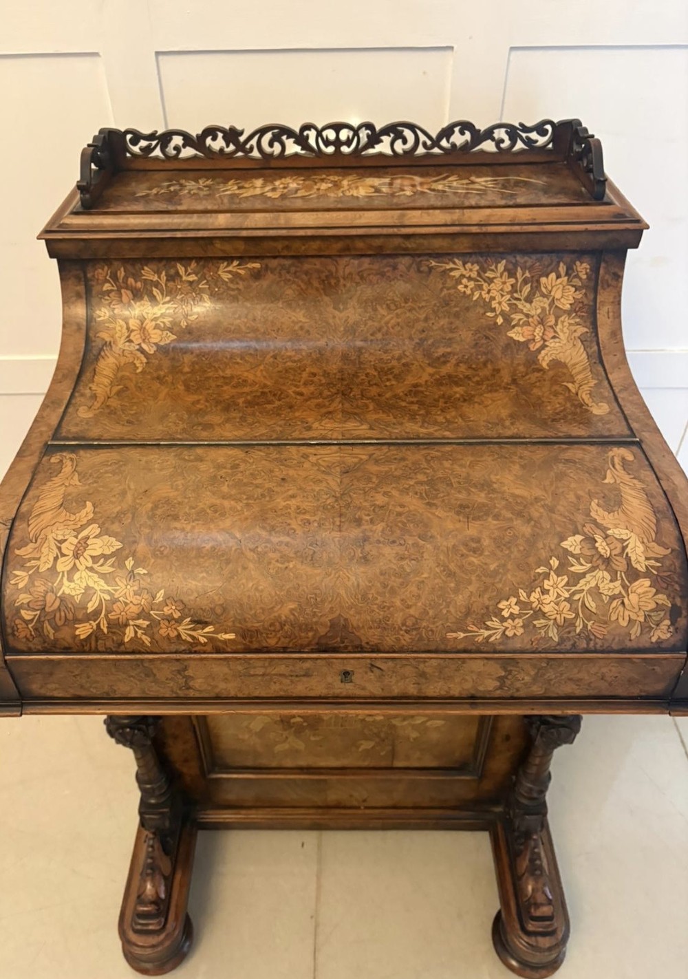 A Victorian burr walnut piano top davenport desk featuring floral marquetry, side drawers with turned wooden knobs, and carved supports. View XIII