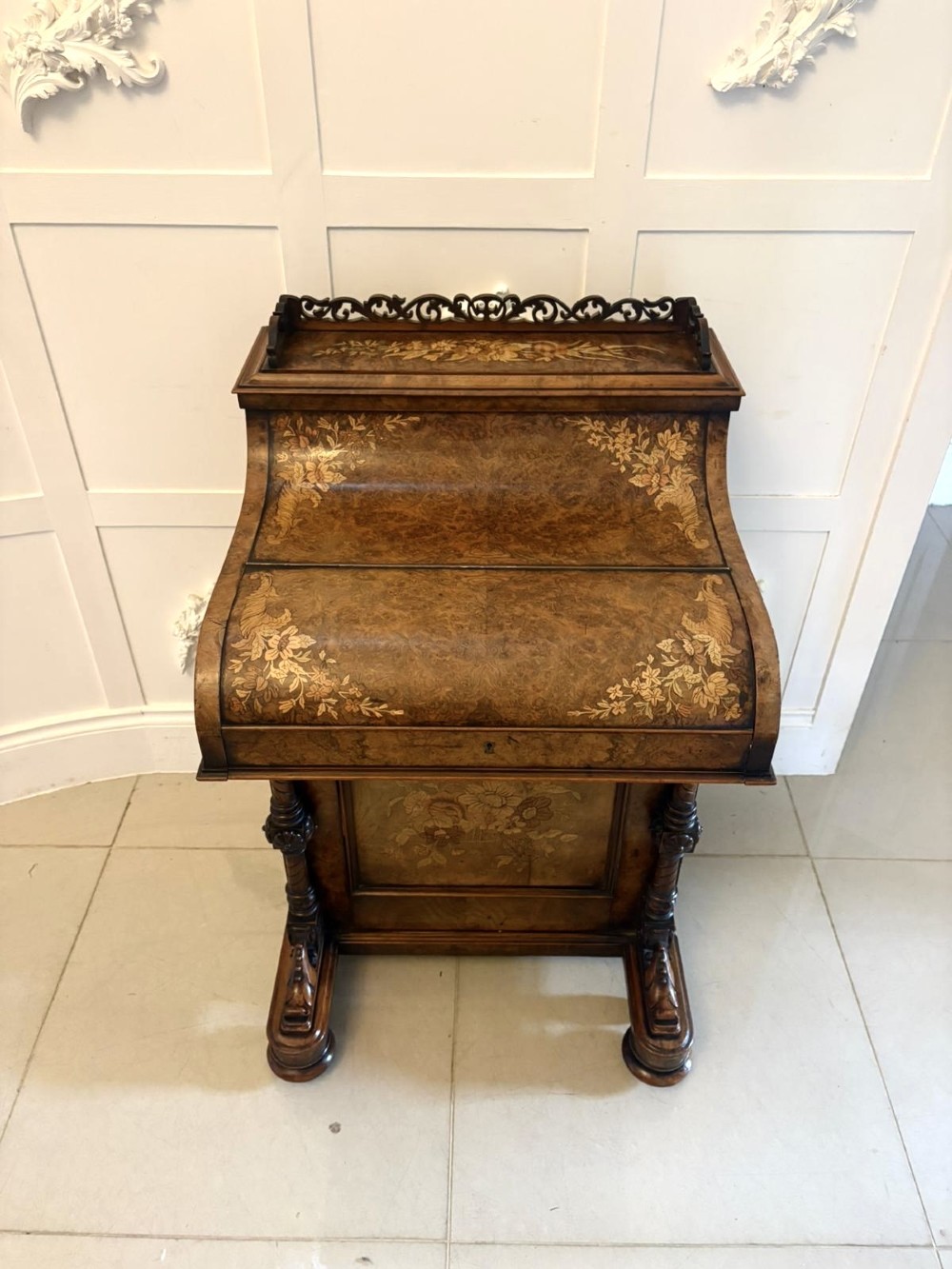 A Victorian burr walnut piano top davenport desk featuring floral marquetry, side drawers with turned wooden knobs, and carved supports. View XIV
