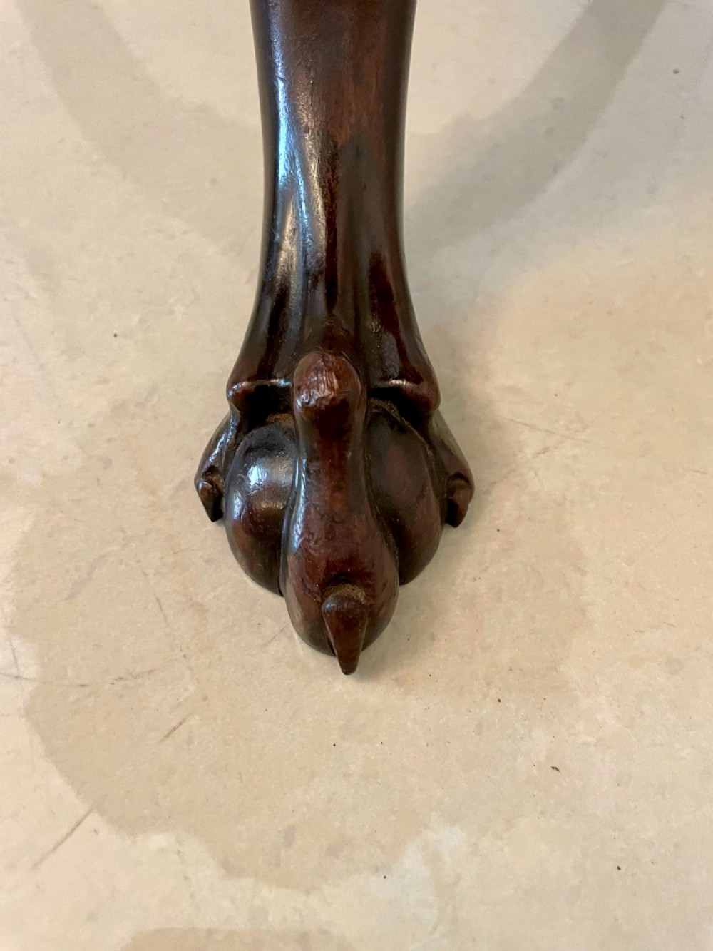 An antique George III mahogany tilt-top table featuring a scalloped pie-crust rim supported by a carved central pedestal and tripod cabriole legs. View VII