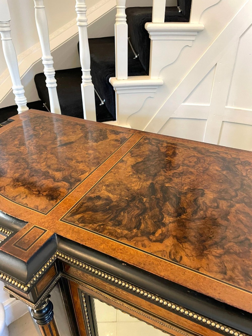 A Victorian burr walnut credenza featuring inlaid amboyna borders, central mirrored doors, curved side glass cabinets, and brass ormolu mounts. View III
