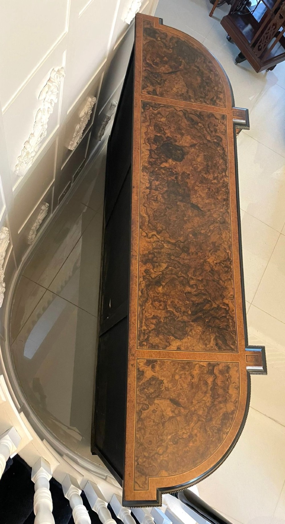 A Victorian burr walnut credenza featuring inlaid amboyna borders, central mirrored doors, curved side glass cabinets, and brass ormolu mounts. View VII
