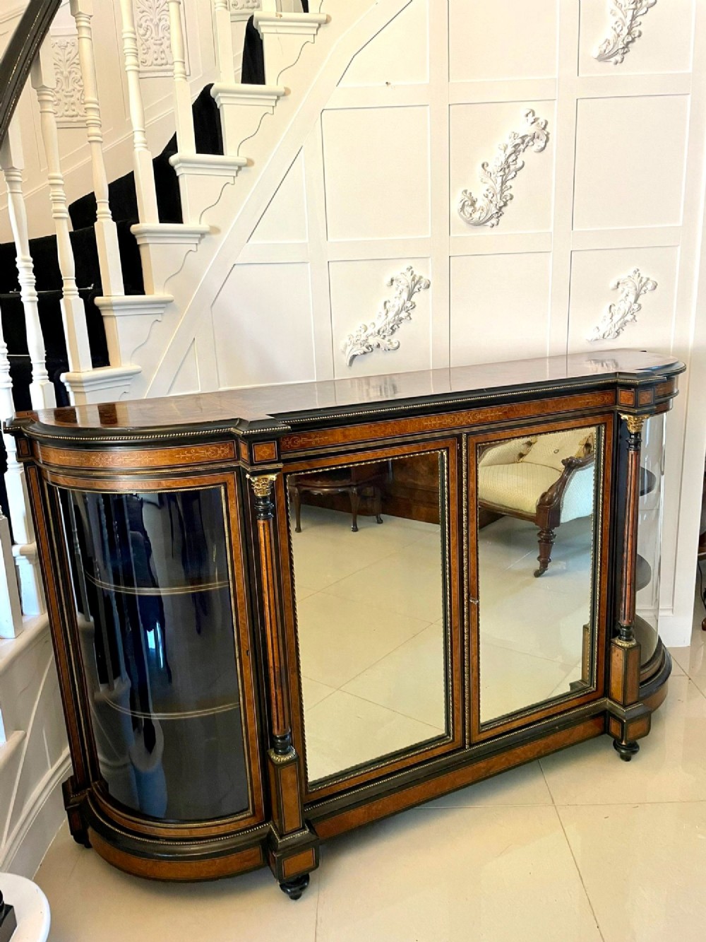A Victorian burr walnut credenza featuring inlaid amboyna borders, central mirrored doors, curved side glass cabinets, and brass ormolu mounts. View XII