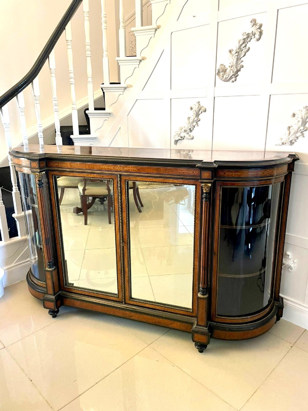 A Victorian burr walnut credenza featuring inlaid amboyna borders, central mirrored doors, curved side glass cabinets, and brass ormolu mounts. View XIII