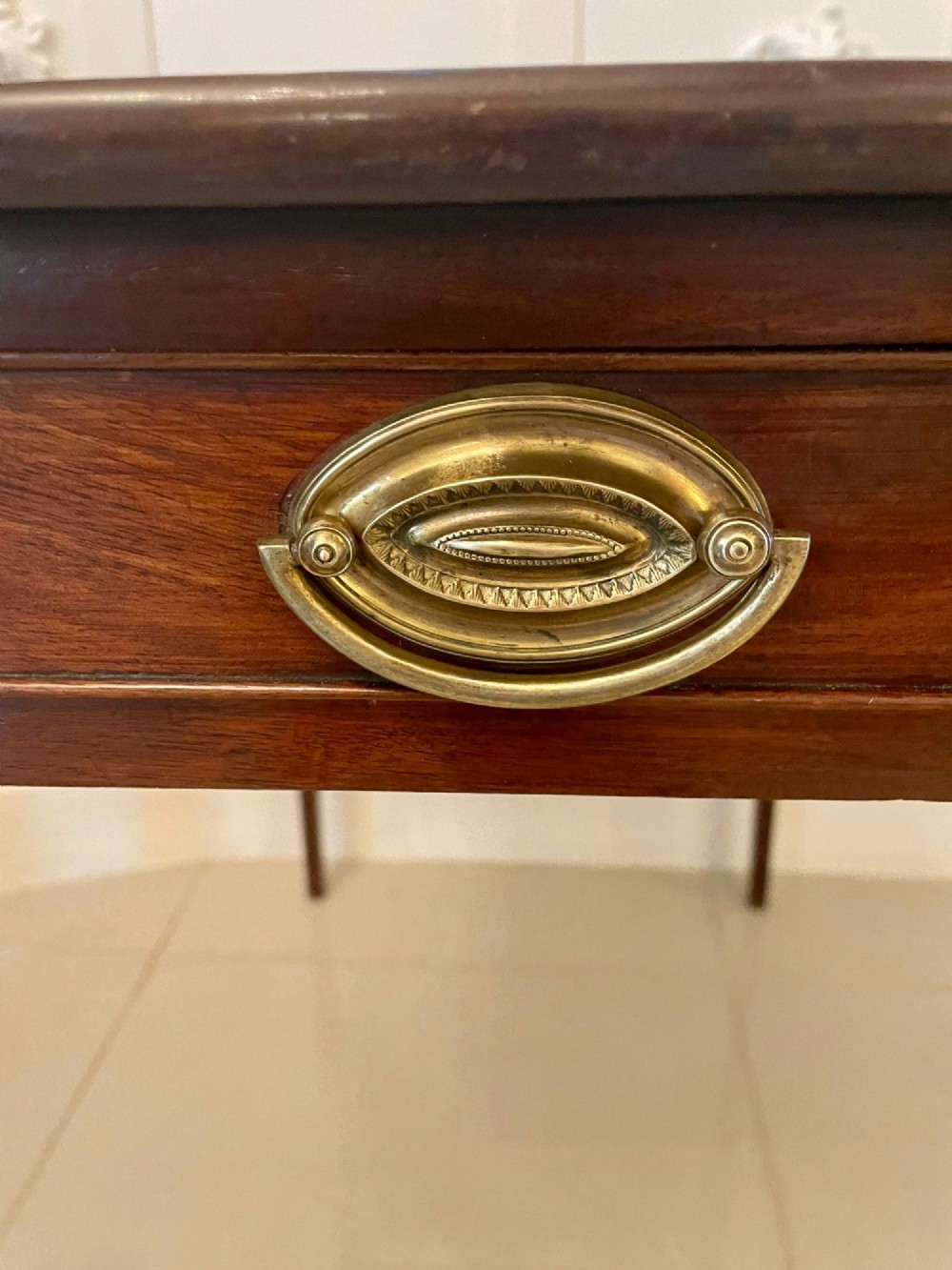 An antique George III mahogany side table featuring square tapered legs and a single side drawer with a brass handle. View III