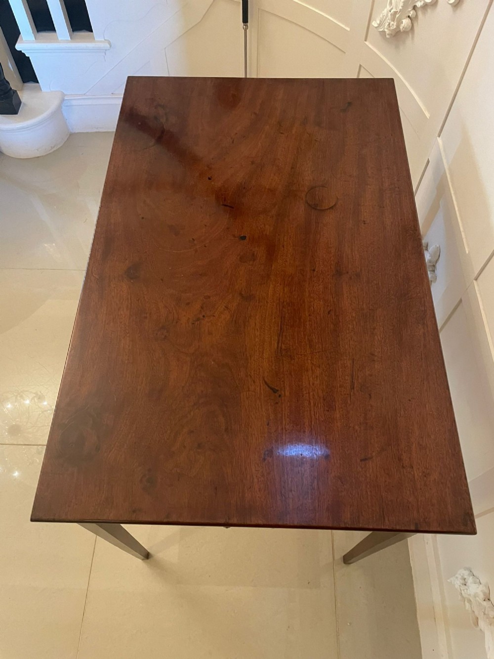 An antique George III mahogany side table featuring square tapered legs and a single side drawer with a brass handle. View IV