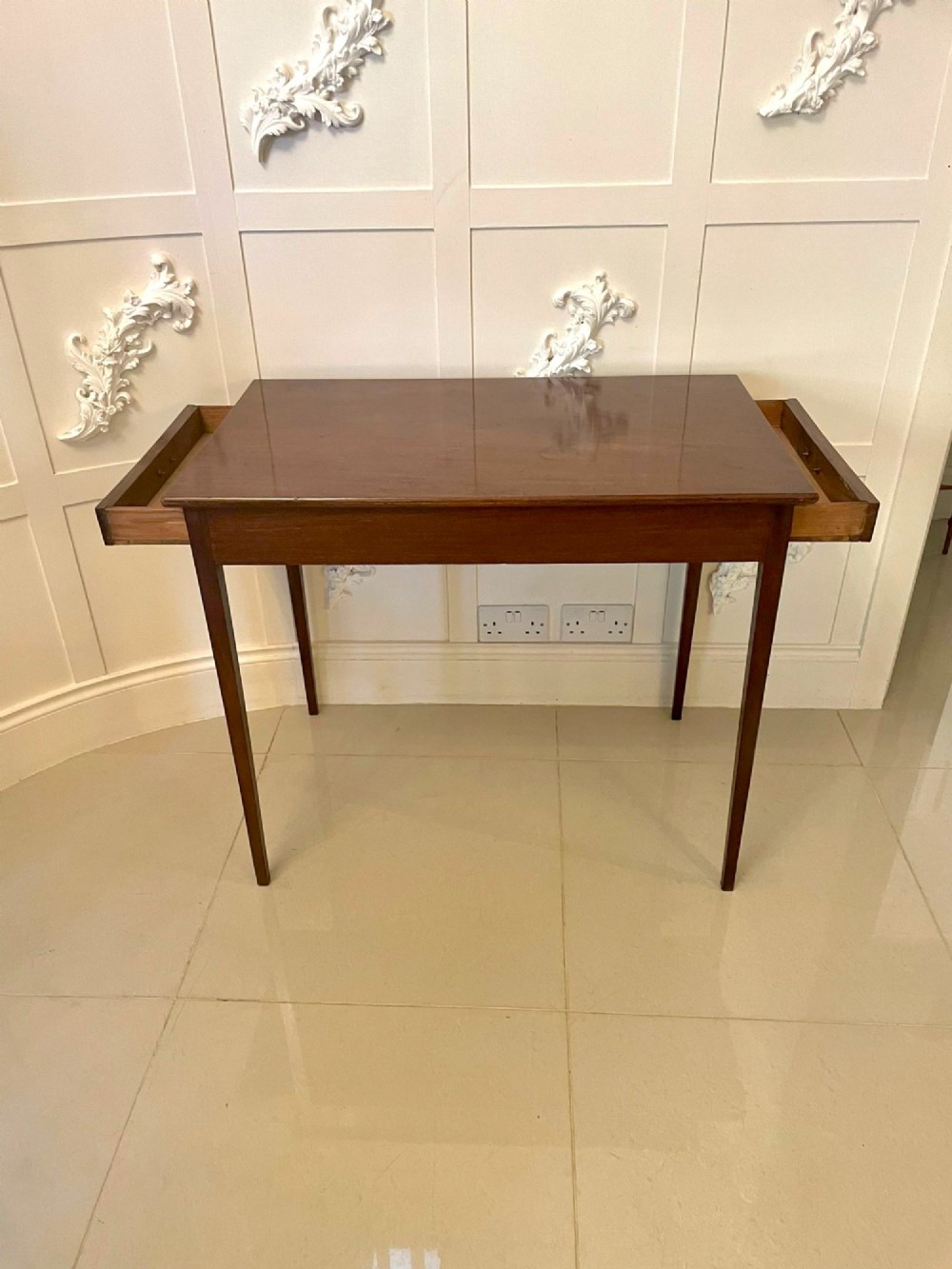 An antique George III mahogany side table featuring square tapered legs and a single side drawer with a brass handle. View IX