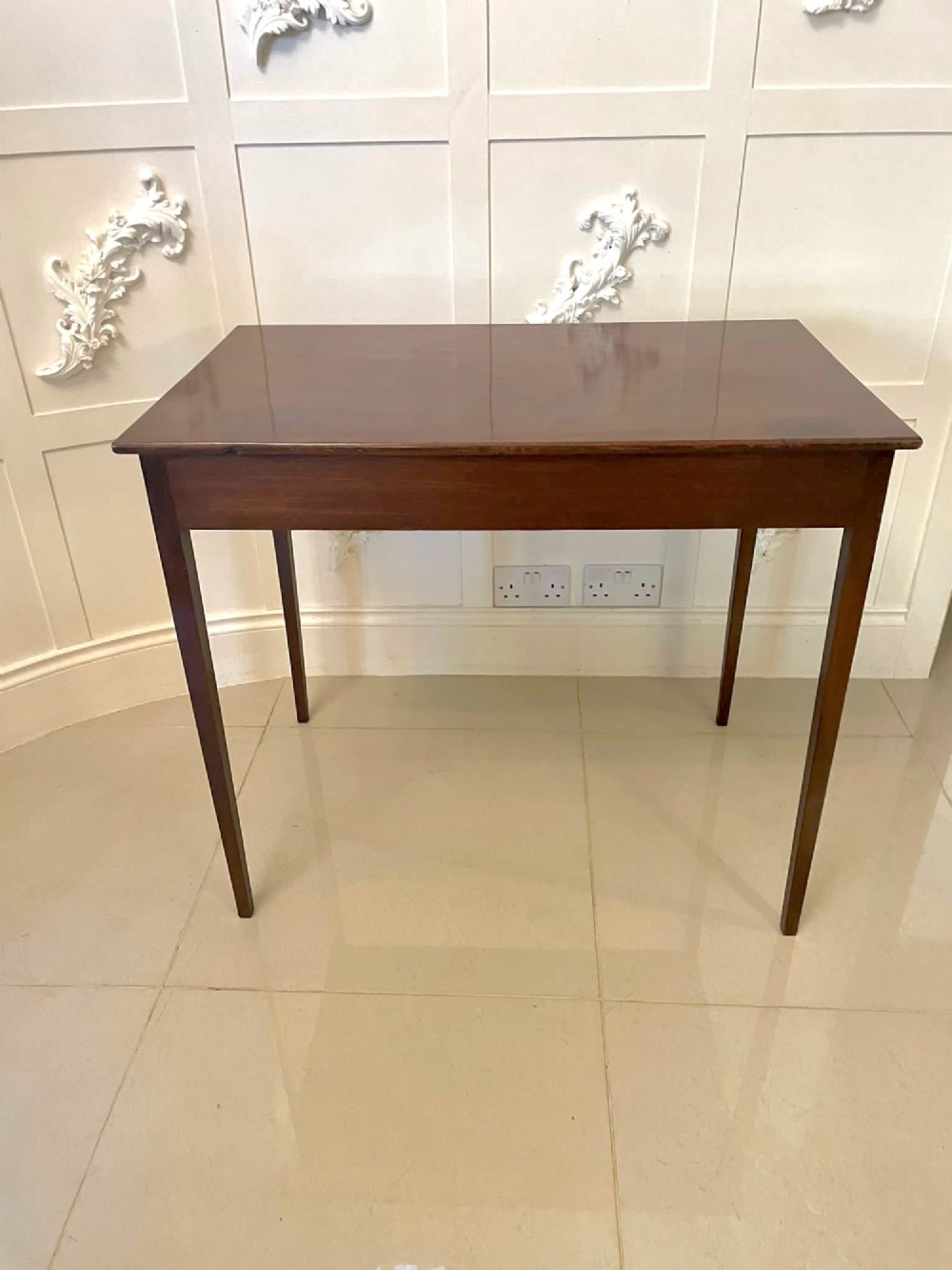 An antique George III mahogany side table featuring square tapered legs and a single side drawer with a brass handle. View XI
