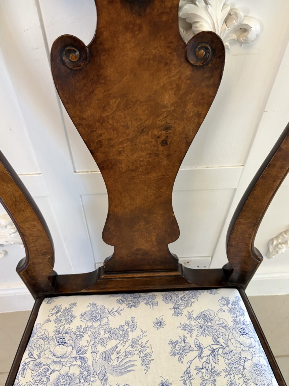 A set of six Victorian burr walnut dining chairs featuring carved top rails, vase-shaped splats, patterned upholstery, and cabriole legs. View III