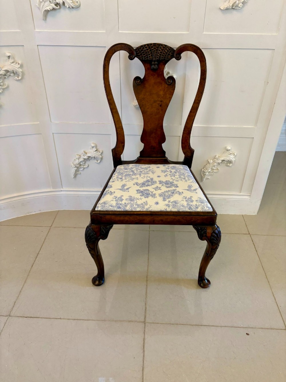 A set of six Victorian burr walnut dining chairs featuring carved top rails, vase-shaped splats, patterned upholstery, and cabriole legs. View VII