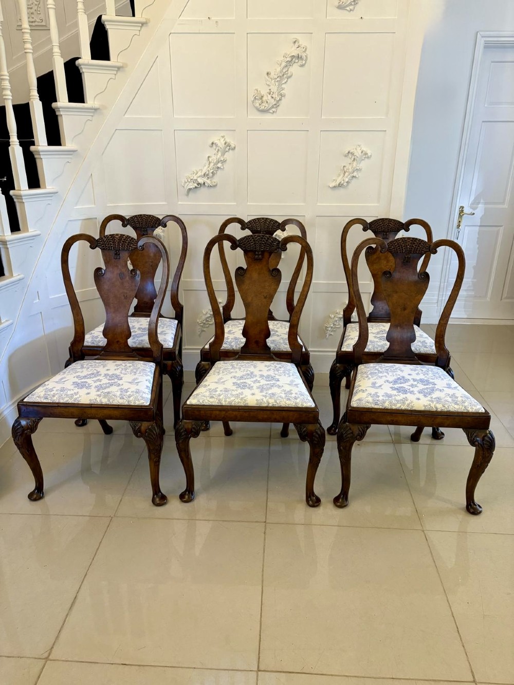A set of six Victorian burr walnut dining chairs featuring carved top rails, vase-shaped splats, patterned upholstery, and cabriole legs. View VIII