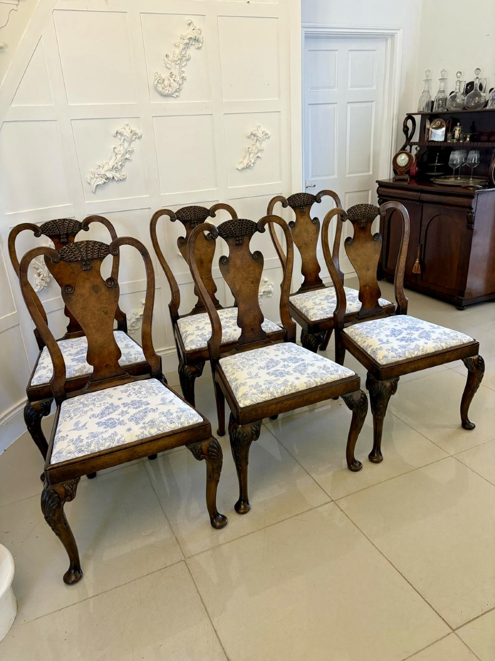 A set of six Victorian burr walnut dining chairs featuring carved top rails, vase-shaped splats, patterned upholstery, and cabriole legs. View XIII