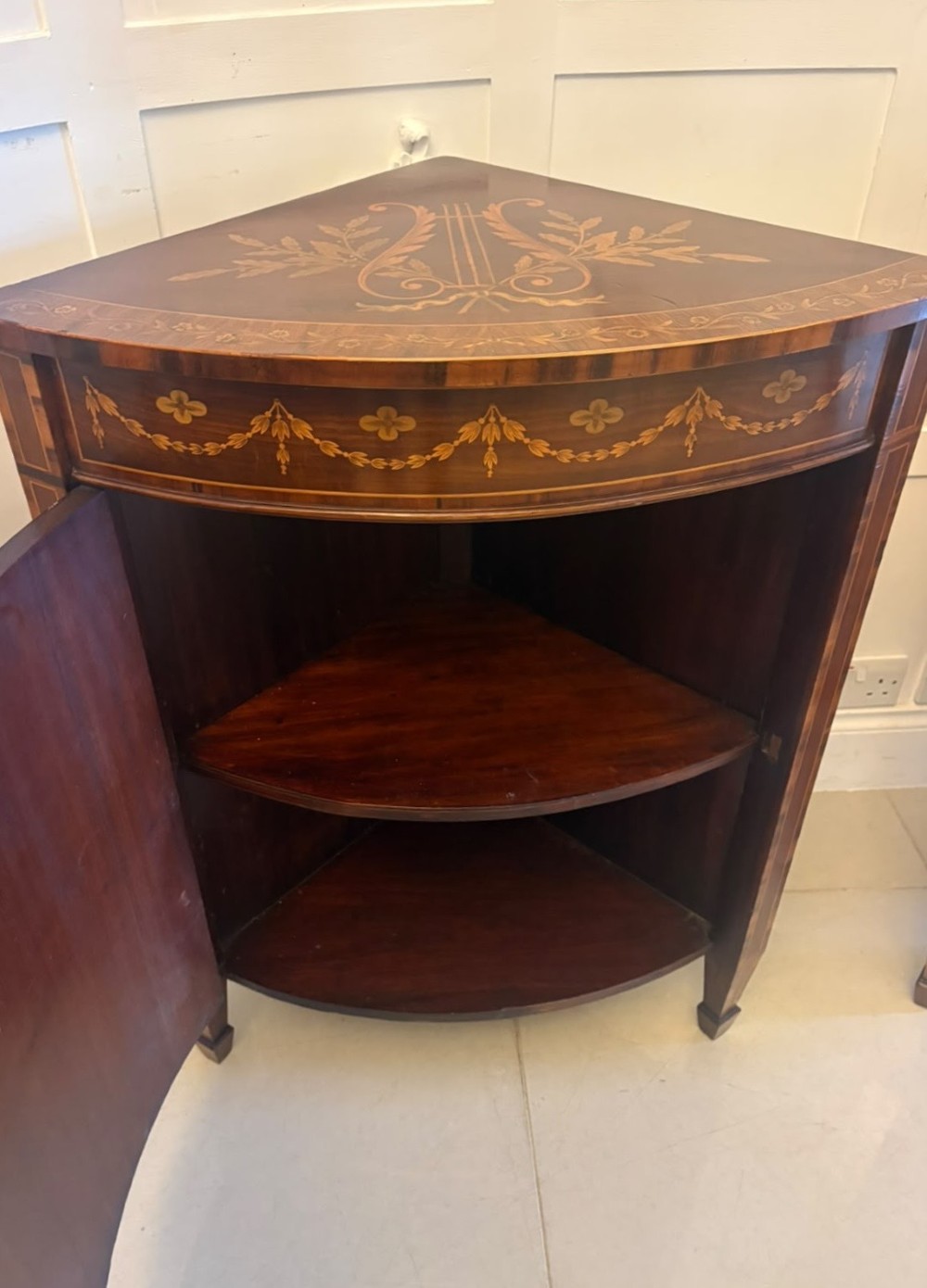 A pair of Victorian mahogany corner cabinets featuring curved bow fronts with floral urn marquetry inlays and tapered square feet. View XI
