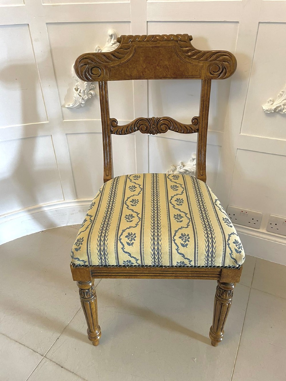 A set of eight antique Regency style dining chairs with faux birds eye maple painted decoration, carved cresting rails, turned legs, and striped upholstery. View IX