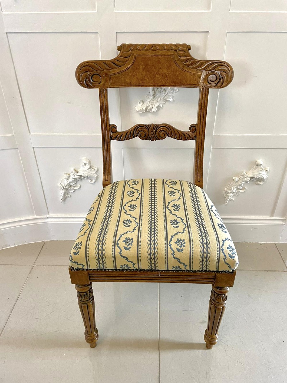 A set of eight antique Regency style dining chairs with faux birds eye maple painted decoration, carved cresting rails, turned legs, and striped upholstery. View XIII