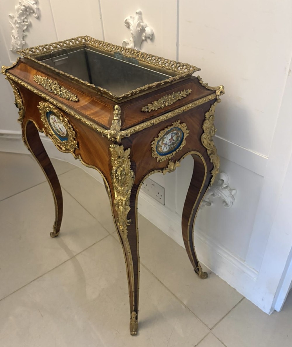 A Louis XV style kingwood jardiniere stand with ornate gilt-bronze ormolu mounts, cabriole legs, and a central porcelain plaque. View XI
