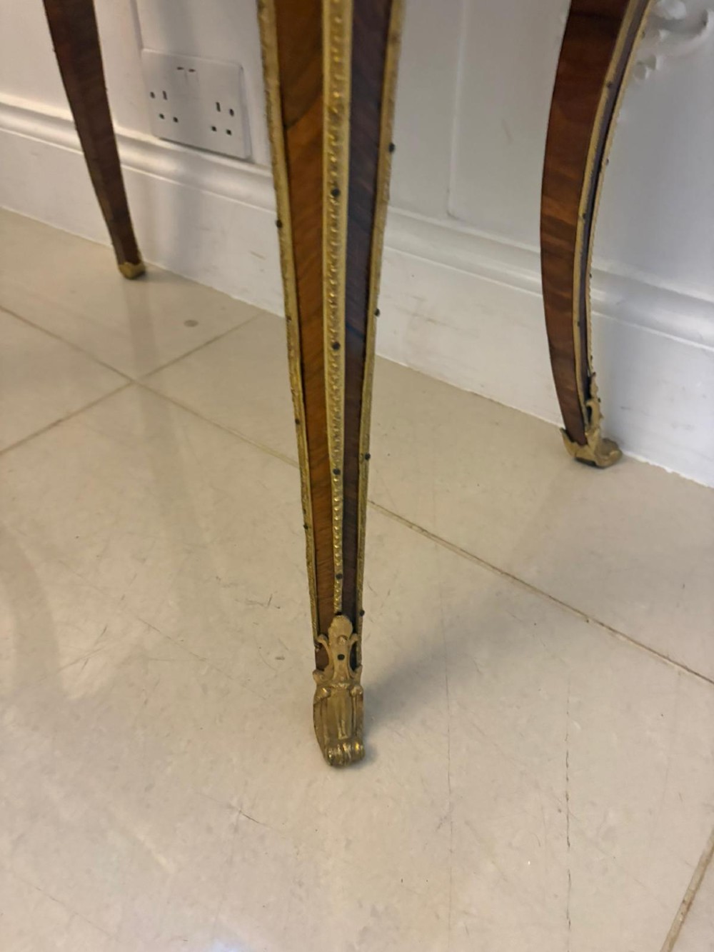 A Louis XV style kingwood jardiniere stand with ornate gilt-bronze ormolu mounts, cabriole legs, and a central porcelain plaque. View XV