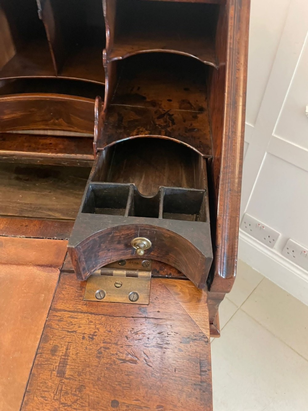 A William and Mary style burr walnut slant-front bureau with herringbone inlay, brass handles, and bun feet. View V