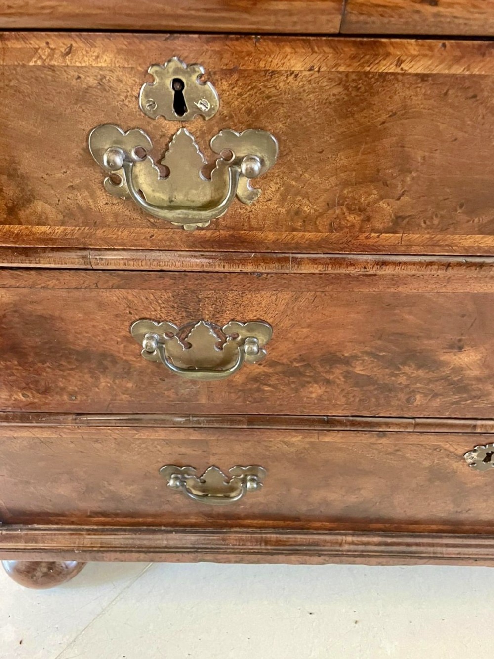 A William and Mary style burr walnut slant-front bureau with herringbone inlay, brass handles, and bun feet. View XI