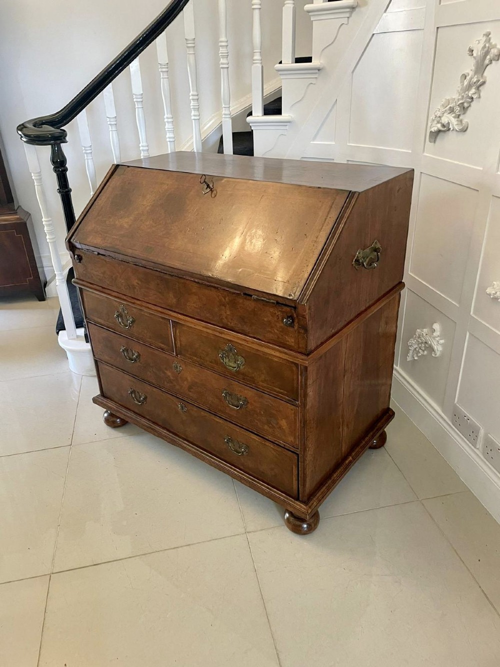A William and Mary style burr walnut slant-front bureau with herringbone inlay, brass handles, and bun feet. View XIII