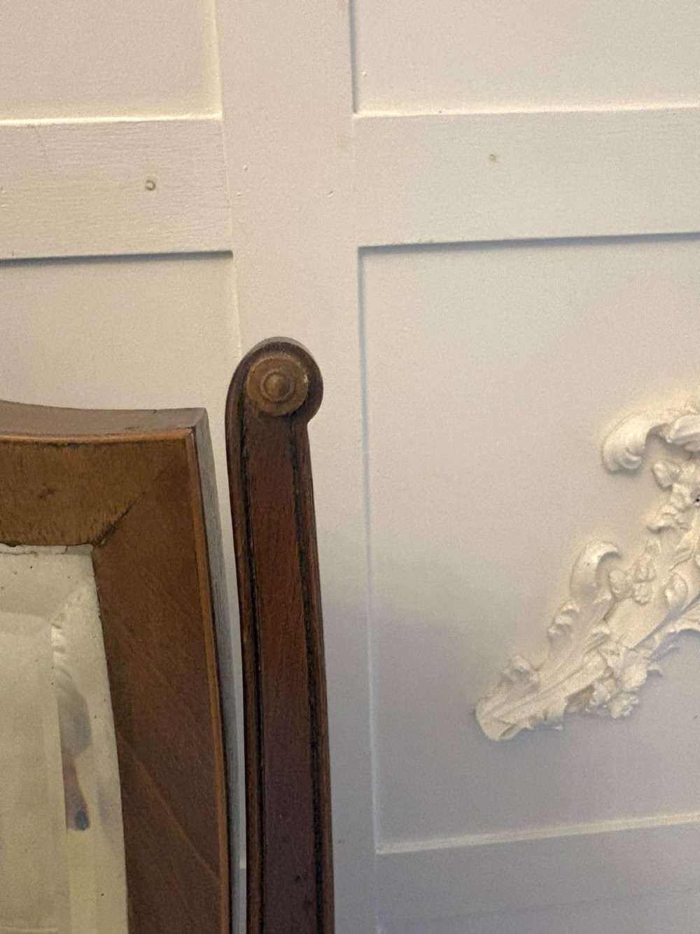 An Edwardian mahogany toilet mirror featuring a shield-shaped frame with bevelled glass mounted on a swivelling stand with brass knobs. View IX