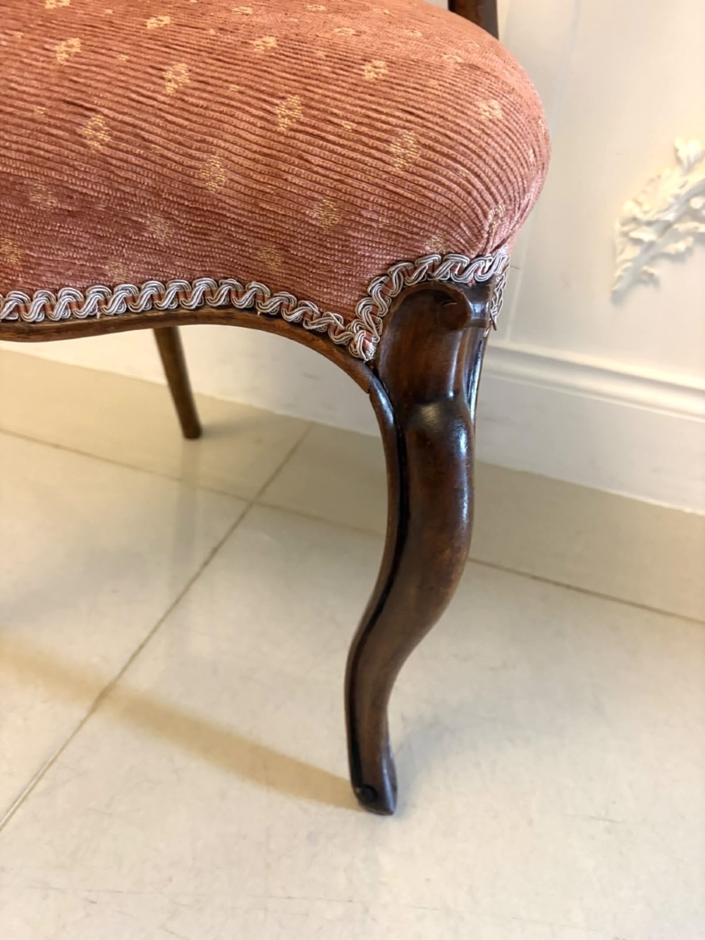 A pair of Victorian carved walnut side chairs featuring open balloon backs with foliate carvings, cabriole legs, and terracotta patterned fabric upholstered seats. View IX